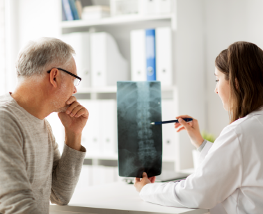 elderly man reviewing an x-ray with a doctor
